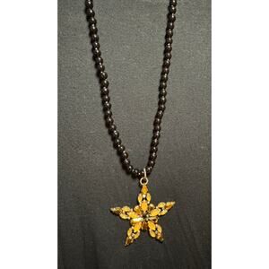 Y60  Gold Colored Star on long black bead necklace